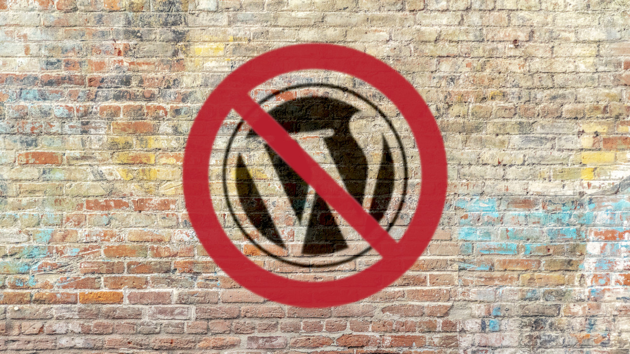 WordPress logo on brick wall covered by red prohibition symbol