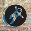 Grav logo covering WordPress logo on brick wall