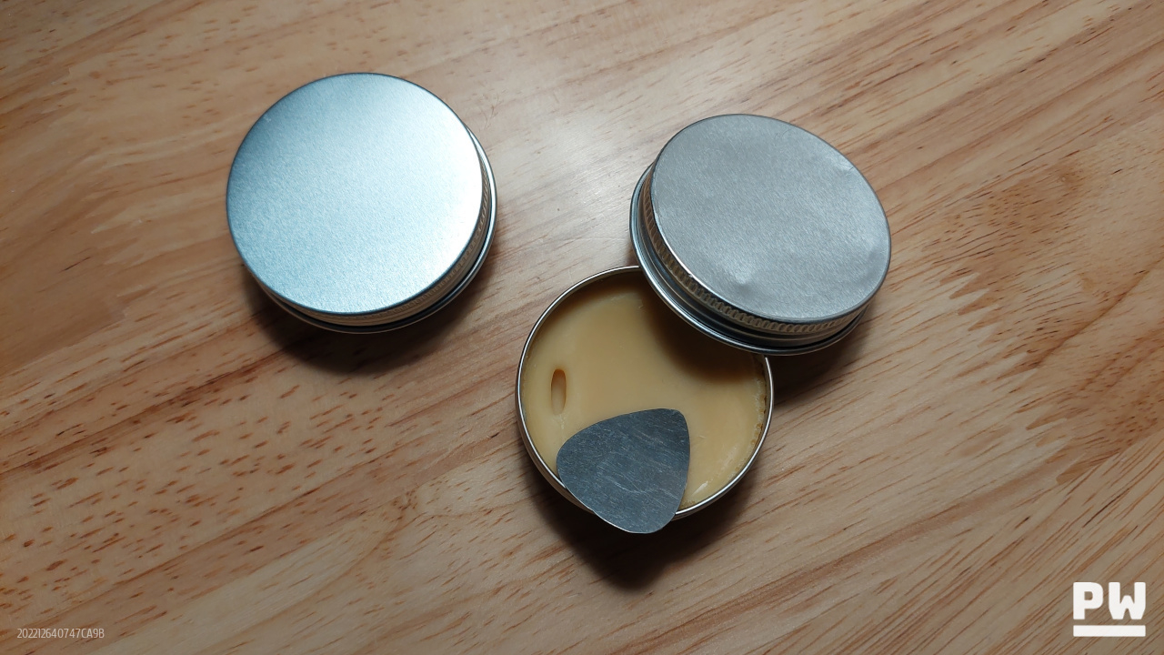 Tin of mustache wax sitting on a table