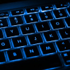 Black keyboard with blue backlighting between keys