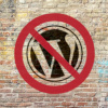 WordPress logo on brick wall covered by red prohibition symbol
