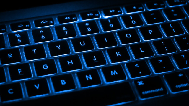 Black keyboard with blue backlighting between keys